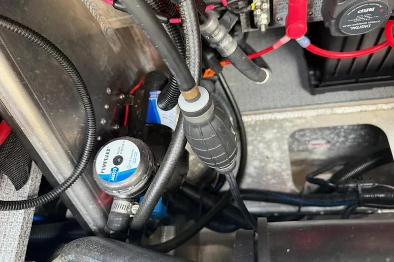 Slide: The Image of Engine compartment of a 2017 KingFisher 2825 Offshore boat, showing wiring and pump components. - 43