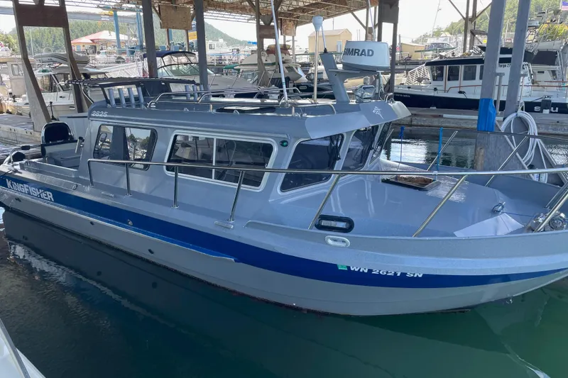 Slide: The Image of 2017 KingFisher 2825 Offshore boat docked in a marina under a covered area. - 6