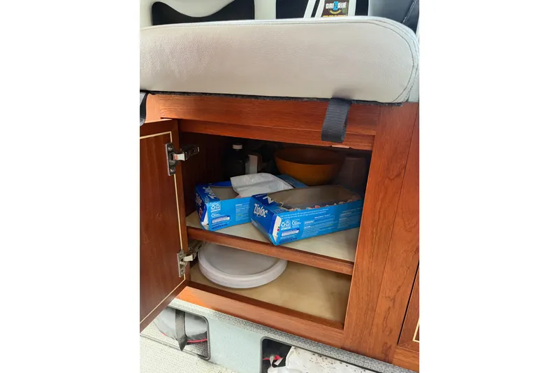 Slide: The Image of Cabinet storage inside 2017 KingFisher 2825 Offshore boat with Ziploc boxes and plates. - 63