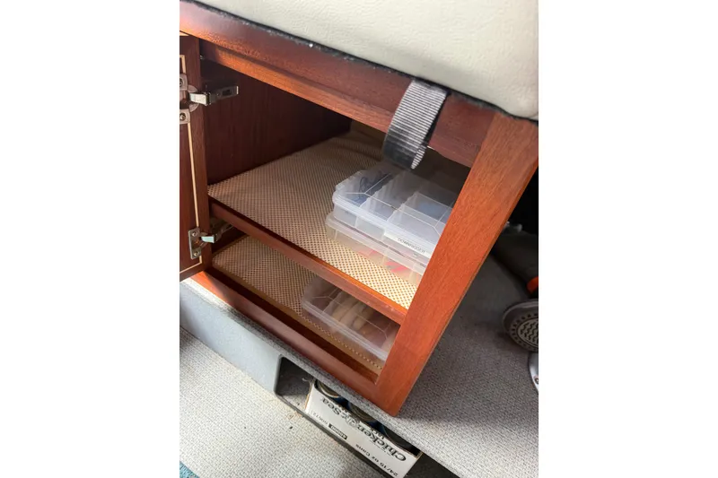 Slide: The Image of Wooden storage cabinet with plastic containers inside a 2017 KingFisher 2825 Offshore boat. - 67