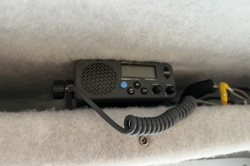 Slide: The Image of VHF radio installed in a 2017 KingFisher 2825 Offshore boat, featuring coiled microphone cable. - 72