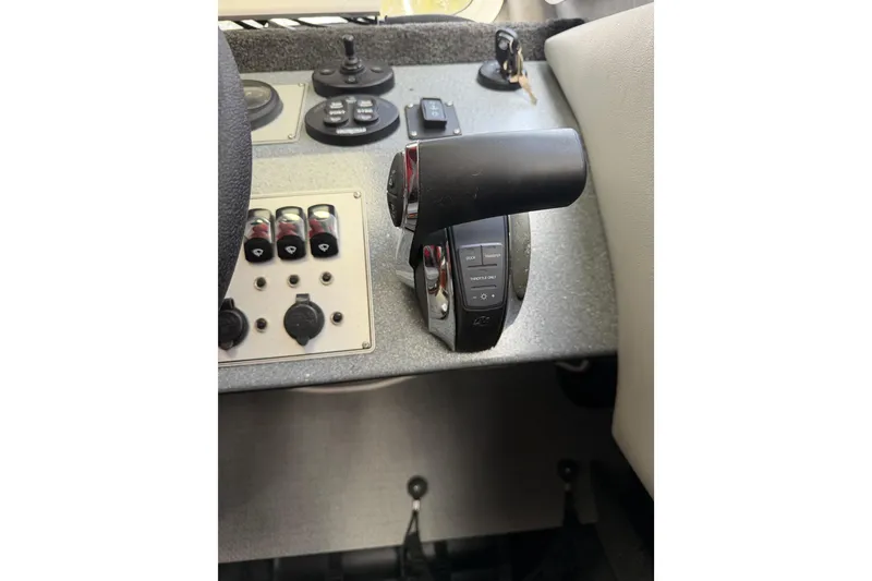 Slide: The Image of Control panel of a 2017 KingFisher 2825 Offshore boat with throttle and switches. - 75