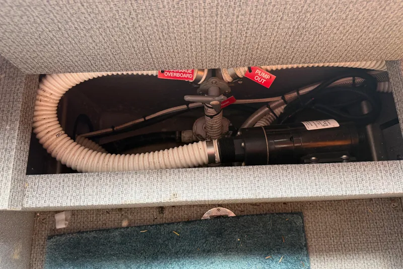 Slide: The Image of 2017 KingFisher 2825 Offshore boat plumbing system with hoses and pump components. - 77