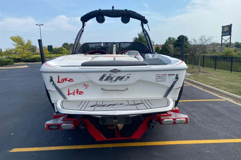 Slide: The Image of 2014 Tigé R20 boat with "Lake Life" decal, parked in a lot. - 2