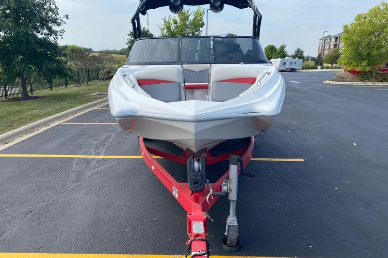 Slide: The Image of 2014 Tigé R20 boat on red trailer in parking lot. - 3