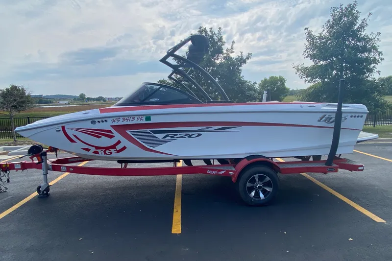 Slide: The Image of 2014 Tigé R20 boat on a trailer in a parking lot, side view. - 4