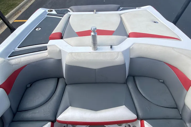 Slide: The Image of 2014 Tigé R20 boat interior with gray and red seating, viewed from above. - 6