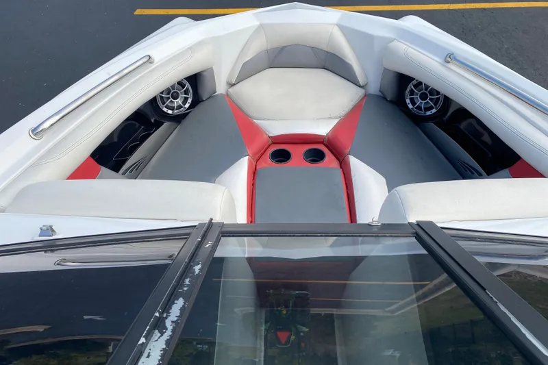 Slide: The Image of Interior of 2014 Tigé R20 boat with red and gray seating and cup holders. - 7