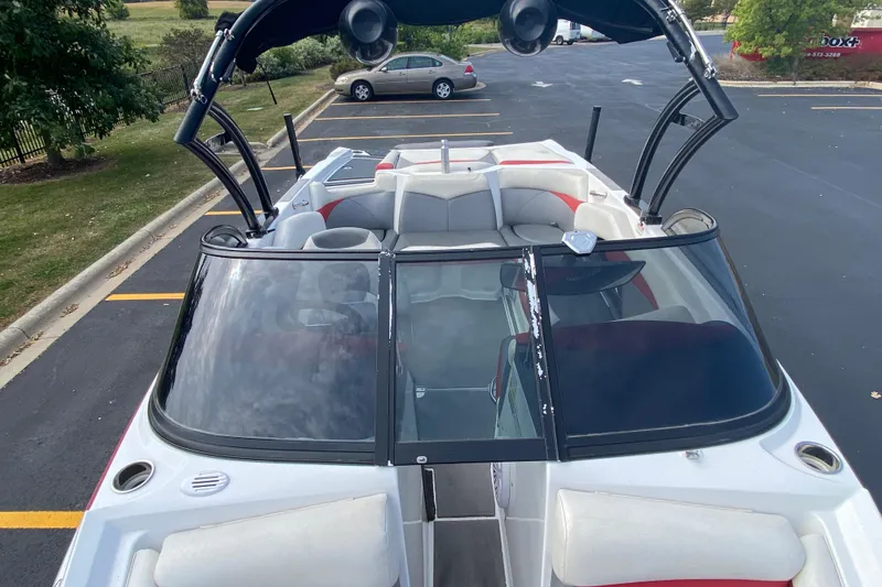 Slide: The Image of 2014 Tigé R20 boat with open seating, parked in a lot. - 8