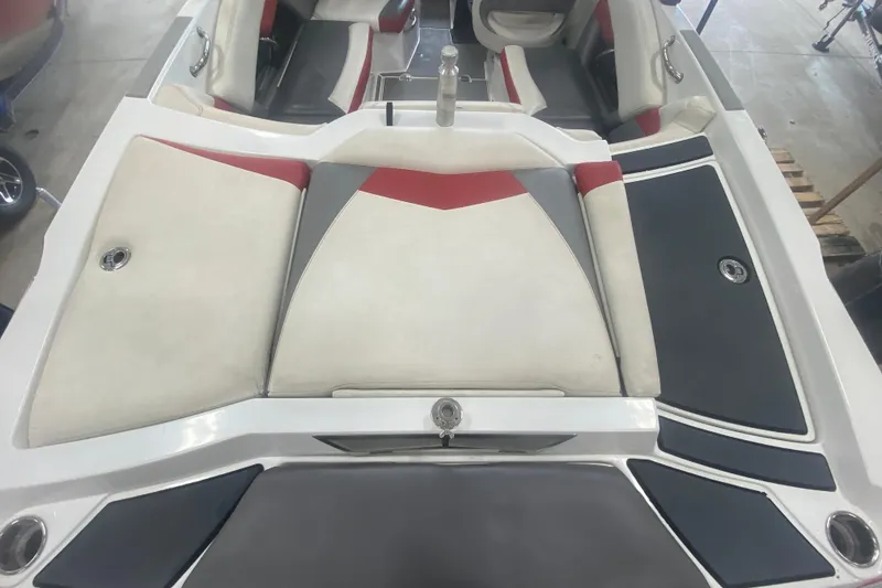 Slide: The Image of 2014 Tigé R20 boat interior with red, white, and gray seating. - 9