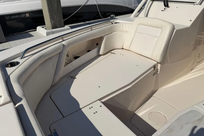 Slide: The Image of 2017 Grady-White Freedom 335 boat interior with white seating and cup holder. - 11