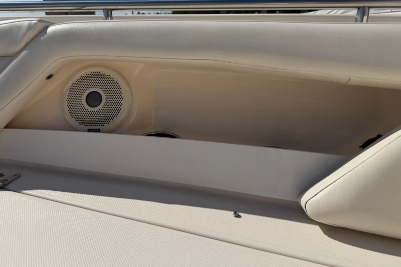 Slide: The Image of 2017 Grady-White Freedom 335 boat interior with speaker and cushioned seating. - 14