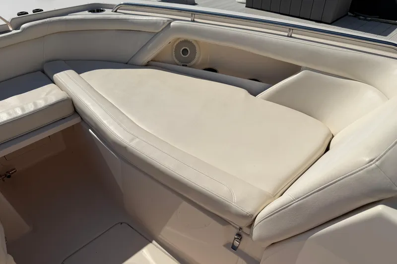 Slide: The Image of 2017 Grady-White Freedom 335 boat interior with beige seating and speaker. - 19