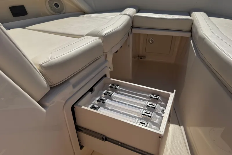 Slide: The Image of 2017 Grady-White Freedom 335 boat interior with storage compartment and cushioned seating. - 20