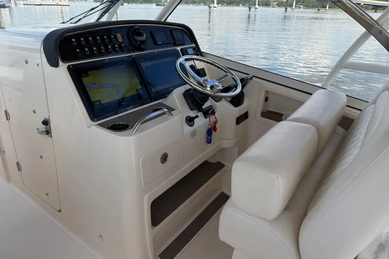Slide: The Image of 2017 Grady-White Freedom 335 boat helm with dual screens and leather seating. - 23