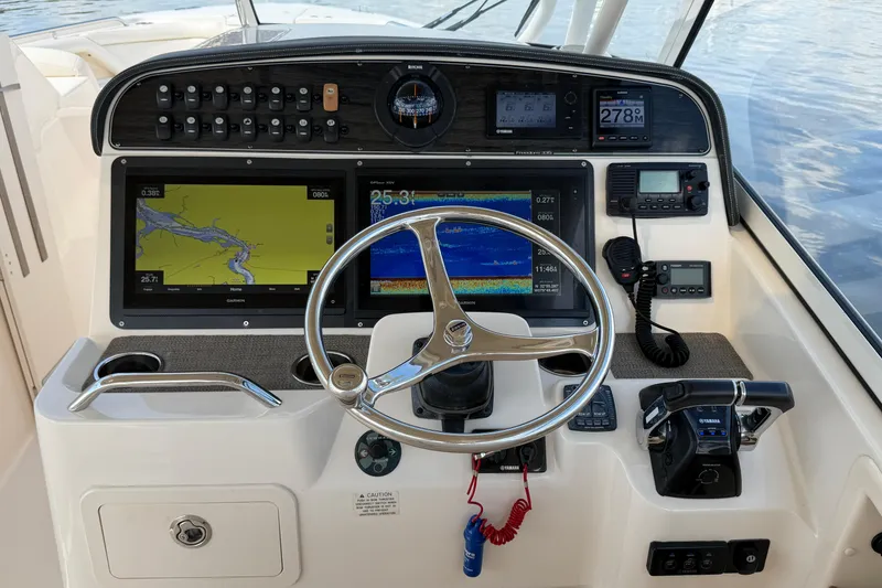 Slide: The Image of 2017 Grady-White Freedom 335 helm with navigation screens and controls. - 24
