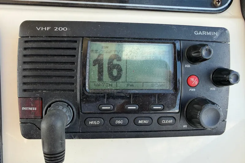 Slide: The Image of Garmin VHF 200 marine radio on 2017 Grady-White Freedom 335 boat dashboard. - 28