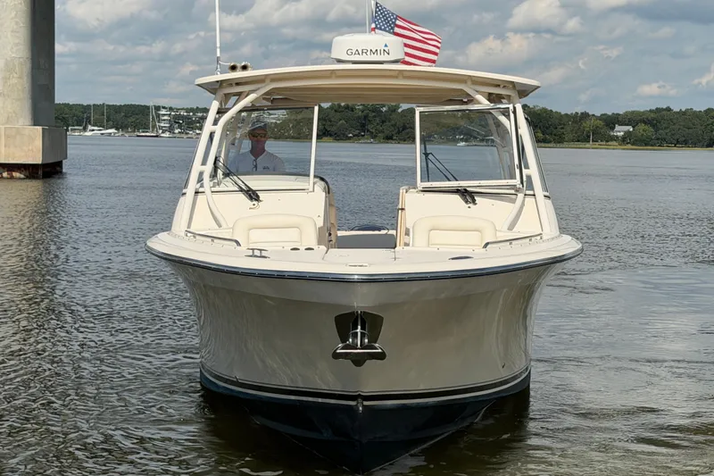 Slide: The Image of 2017 Grady-White Freedom 335 boat on calm water, American flag displayed. - 3