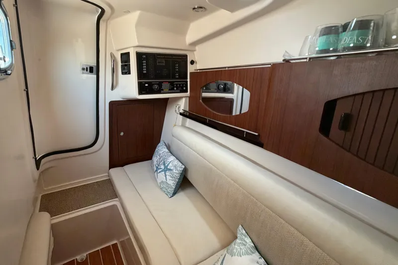Slide: The Image of 2017 Grady-White Freedom 335 cabin interior with seating and control panel. - 36