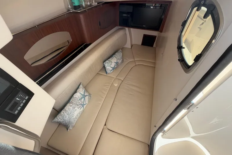 Slide: The Image of Interior of 2017 Grady-White Freedom 335 boat with beige seating and decorative pillows. - 37