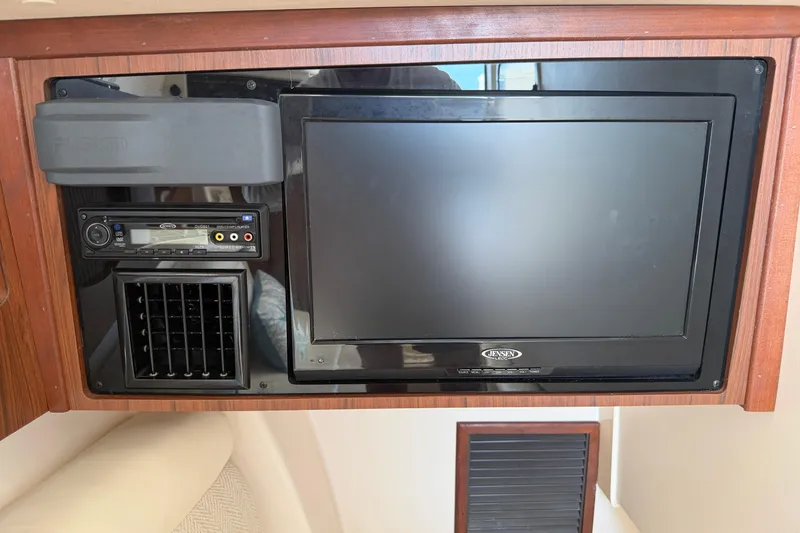 Slide: The Image of 2017 Grady-White Freedom 335 interior with Jensen TV and audio system. - 38