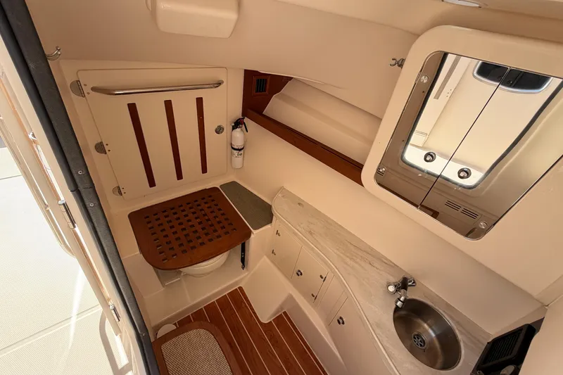 Slide: The Image of 2017 Grady-White Freedom 335 boat interior with sink, mirror, and wooden accents. - 41
