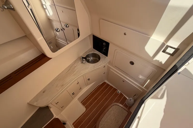 Slide: The Image of 2017 Grady-White Freedom 335 boat interior with sink, cabinets, and wood flooring. - 42