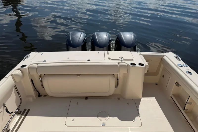 Slide: The Image of 2017 Grady-White Freedom 335 boat with triple outboard motors on calm water. - 45
