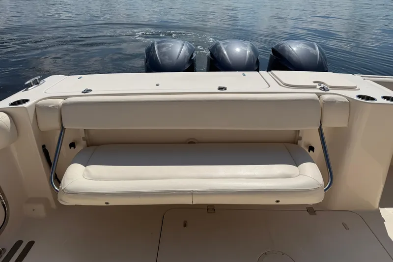 Slide: The Image of 2017 Grady-White Freedom 335 boat with cushioned seating and triple outboard motors. - 47