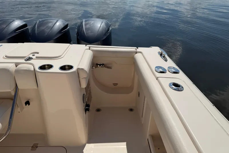 Slide: The Image of 2017 Grady-White Freedom 335 boat interior with cup holders and outboard motors. - 48