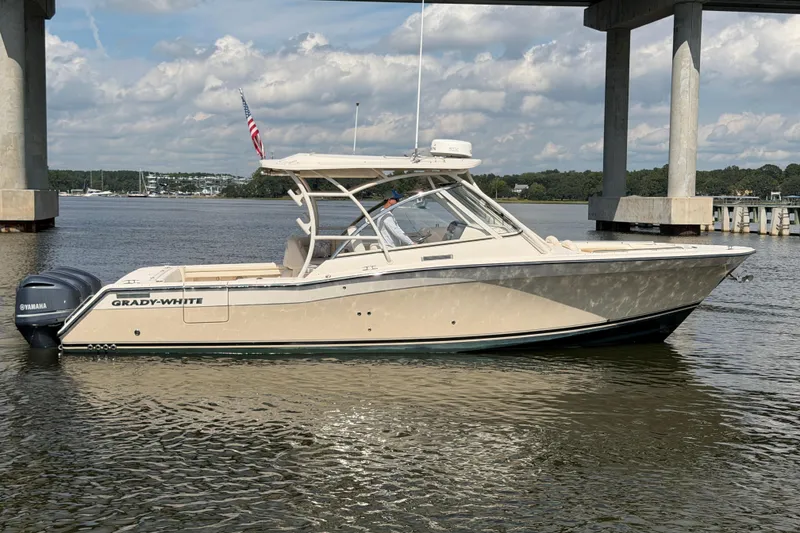 Slide: The Image of 2017 Grady-White Freedom 335 boat on water, under a bridge, with Yamaha engines. - 5