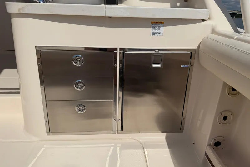 Slide: The Image of 2017 Grady-White Freedom 335 boat interior with stainless steel storage compartments. - 52