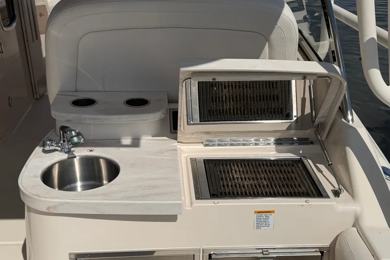 Slide: The Image of 2017 Grady-White Freedom 335 boat kitchenette with sink and grill. - 54