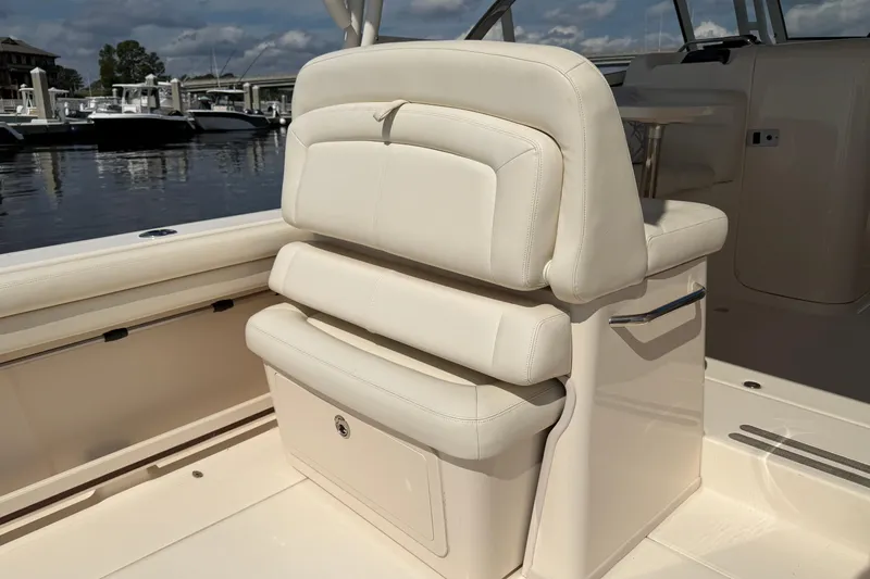 Slide: The Image of 2017 Grady-White Freedom 335 boat interior with white cushioned seating. - 55