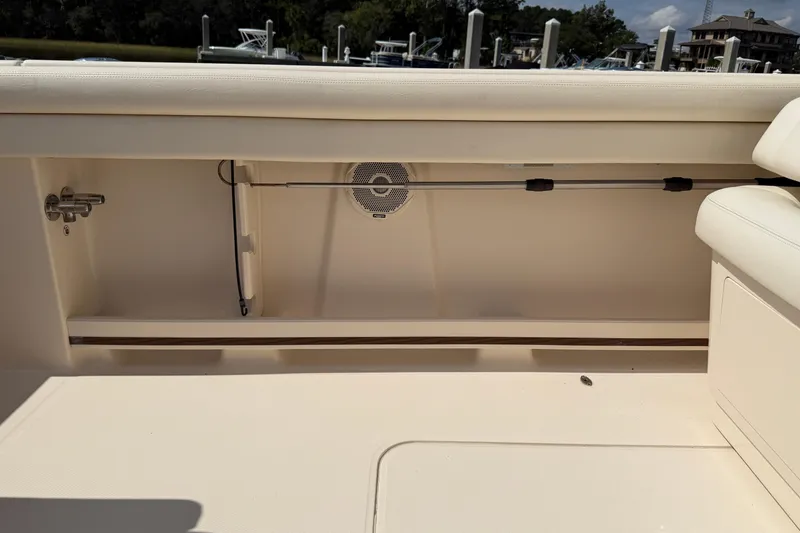 Slide: The Image of 2017 Grady-White Freedom 335 boat interior with storage compartment and speaker. - 56