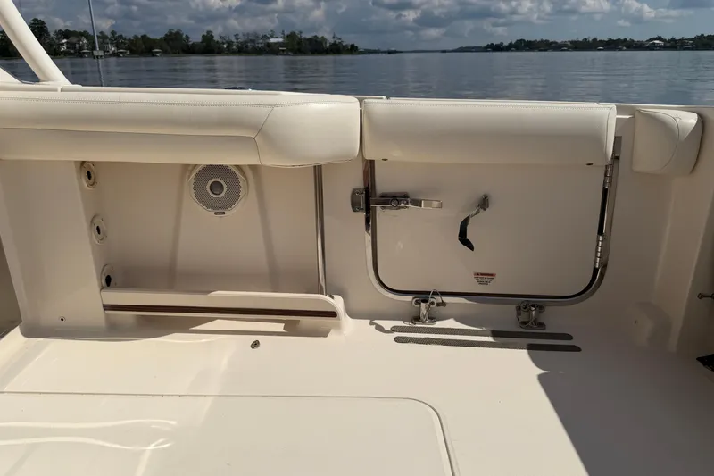 Slide: The Image of 2017 Grady-White Freedom 335 boat interior with seating and storage, overlooking calm waters. - 57