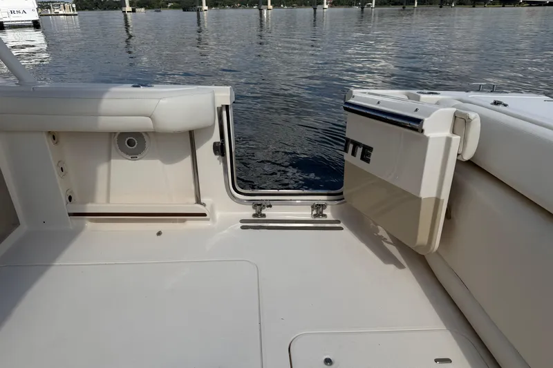 Slide: The Image of 2017 Grady-White Freedom 335 boat interior with open transom door on calm water. - 58