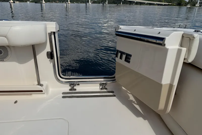 Slide: The Image of 2017 Grady-White Freedom 335 boat interior with open side door, overlooking calm water. - 59