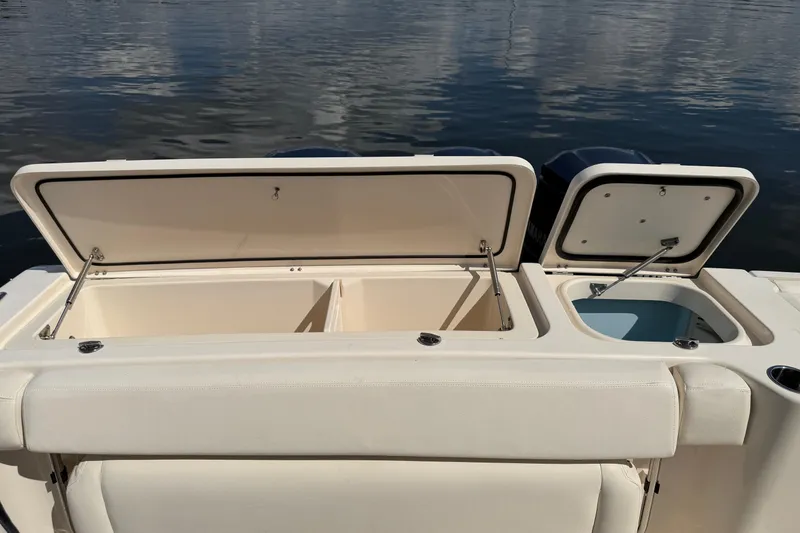 Slide: The Image of 2017 Grady-White Freedom 335 boat with open storage compartments on calm water. - 60