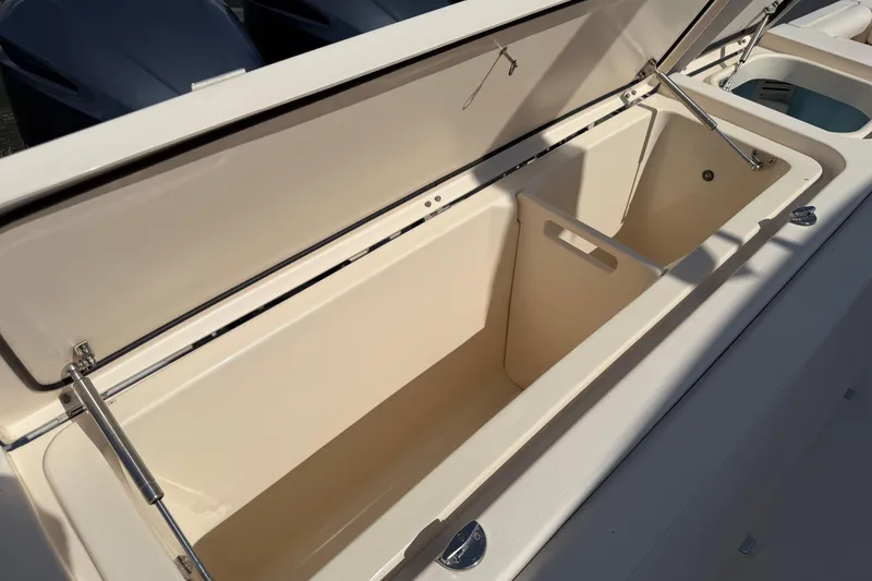 Slide: The Image of Open storage compartment on a 2017 Grady-White Freedom 335 boat, showcasing spacious interior. - 62
