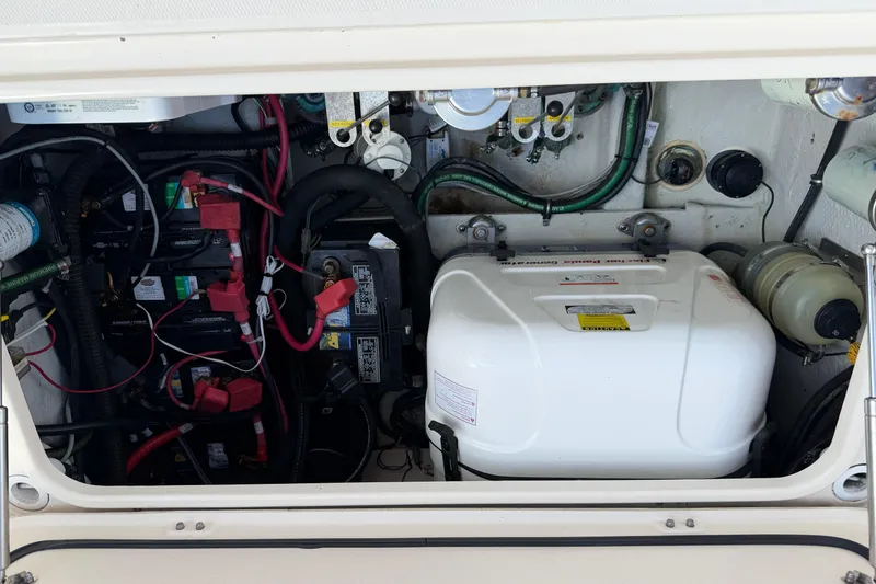 Slide: The Image of Engine compartment of 2017 Grady-White Freedom 335 boat, showing batteries and wiring. - 63