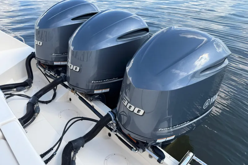 Slide: The Image of Triple Yamaha outboard engines on a 2017 Grady-White Freedom 335 boat. - 65