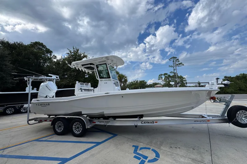 Slide: The Image of 2026 Caymas 28 HB boat on trailer under cloudy sky. - 10