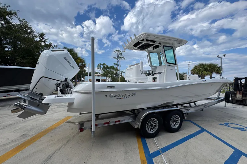 Slide: The Image of 2026 Caymas 28 HB boat on trailer, featuring a powerful Mercury outboard motor. - 12