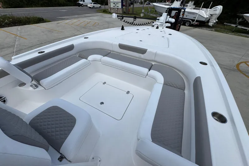 Slide: The Image of 2026 Caymas 28 HB boat interior with cushioned seating and storage compartments. - 19