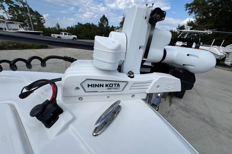 Slide: The Image of Minn Kota Instinct motor on 2026 Caymas 28 HB boat, parked outdoors. - 22