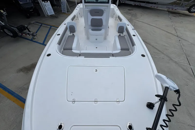 Slide: The Image of 2026 Caymas 28 HB boat deck with seating and trolling motor, displayed outdoors. - 23