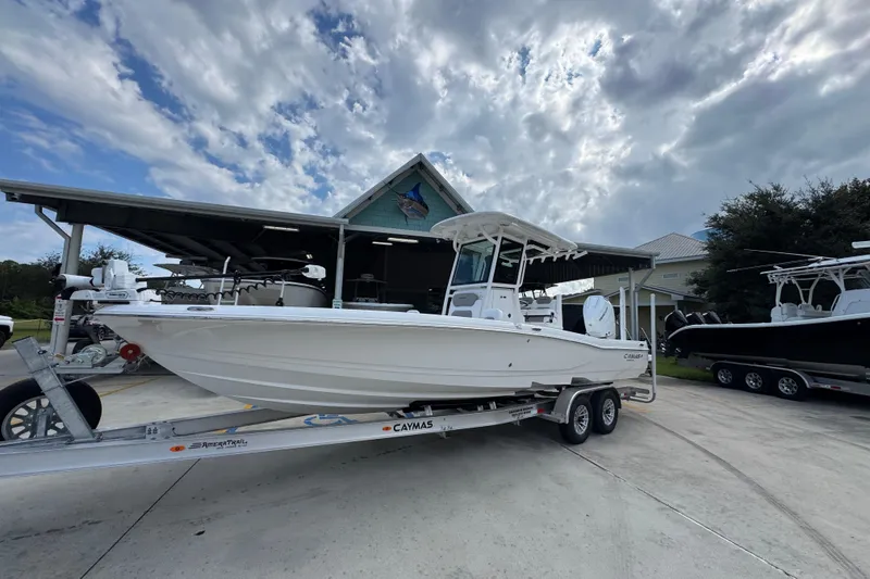 Slide: The Image of 2026 Caymas 28 HB boat on trailer, parked outdoors under cloudy sky. - 3