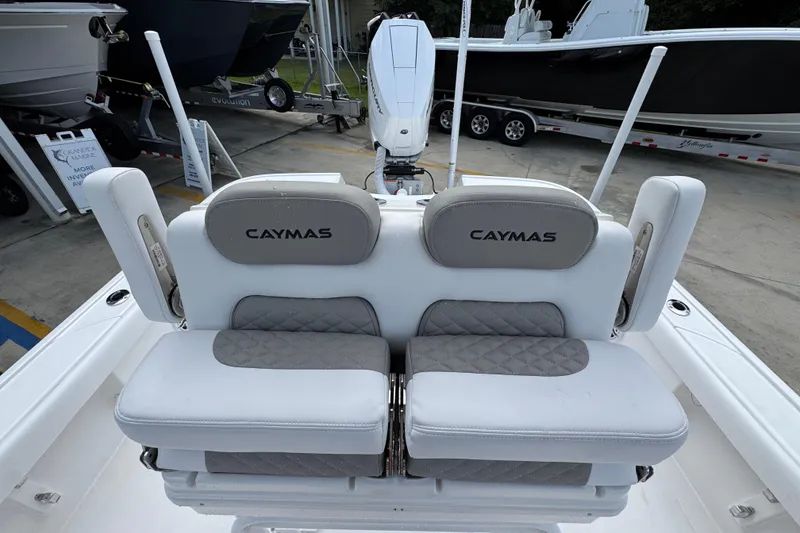 Slide: The Image of 2026 Caymas 28 HB boat interior with cushioned seating and branded headrests. - 30
