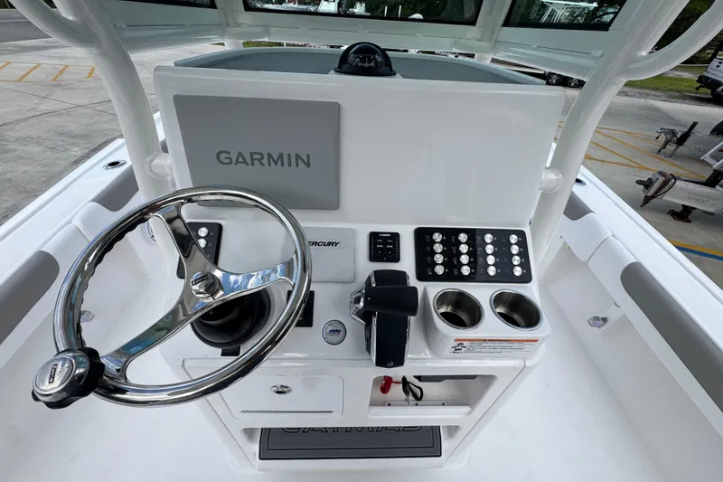 Slide: The Image of 2026 Caymas 28 HB boat console with Garmin display and steering wheel. - 33